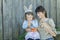 Woman and preschooler girl with cute Easter rabbit and carrots in arms