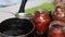 A woman preserves sun-dried tomatoes. Fill them with hot vegetable oil. The camera zooms in on the slider. Close-up