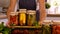 A woman is preserving vegetables in the kitchen. Selective focus.