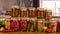 A woman is preserving vegetables in the kitchen. Selective focus.