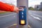 Woman press on box with pedestrian on traffic light