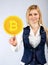 The woman presses the bitcoin icon with her finger