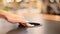 A woman presses a button on a desk. Modern hidden socket.