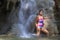 Woman pretty body big with bikini on waterfall