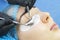 Woman on the procedure for eyelash extensions,