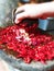 a woman is processing traditional cooking spices