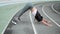 Woman with prosthetic leg doing yoga on racetrack. Lady stretching body