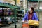 Woman with protection face mask and shopping cart at supermarket