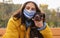 Woman in protective mask with German Shorthaired Pointer outdoors. Walking dog during COVID-19 pandemic