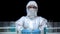 Woman in protective mask and glasses preparing for toxic work in laboratory