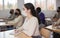 Woman in protective mask listening to lesson in extension school