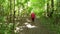 A woman in a protective mask walks in a Park with sticks for Nordic walking, a walk in the fresh air after quarantine, a