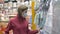 Woman in protective mask walks in supermarket, personal protection coronavirus pandemic covid-19