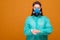 woman in protective medical equipment with antiseptic in hands medical mask on face on a yellow background, coronavirus pandemic