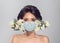 Woman in protective medical mask with flowers