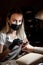 Woman in protective medical mask and manicurist. Beauty salons, manicure, nail care. Portrait of young woman manicurist in mask