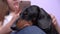 Woman providing video chat through mobile phone, dachshund falling asleep