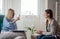 Woman psychotherapist consults patient sitting in armchair at