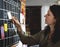 Woman pulling sticky note from calendar plan on wall