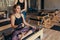 Woman pulling a stretch band sitting on pilates training machin