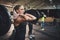 Woman pulling up large barbell in fitness class