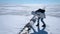 A woman pulls out small ice floe from a crack with water on Lake Baikal, Russia.