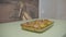 woman pulls ready food out of the oven and puts on the table, potatoes with chicken, home cooking