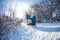 A woman pulls a sled with a child