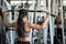 Woman pumping back muscles in gym