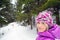 Woman in purple jacket on snowy trail in Karkonosze Mountains, Poland