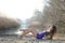 Woman in a purple short dress lying on dry reeds