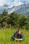 Woman with purple wild flowers (Alps, Switzerland)