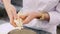 Woman pushes the dough from the bag