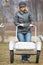 Woman pushing empty barrow