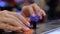 Woman pushing orange buttons of retro arcade machine - close up view