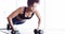 Woman, pushups and dumbbell for workout at gym, strong core and endurance training for body. Female person, sweat and