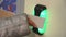 Woman put key card to blue electronic indicator, green color turn on. Door. Entrance control system