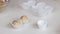 A woman puts balls of peanut butter, chocolate and coconut flour into paper tartlets. Prepares healthy sweets. Close-up shot