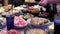 A woman puts boiled potatoes in a plate at the festive table. Many dishes on the table, homemade