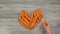 Woman puts carrots in the shape of a heart timelapse