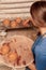 Woman puts clay pots on the shelf