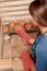 Woman puts clay pots on the shelf