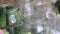 A woman puts cucumbers in pickling jars. Harvest conservation. Close-up shot