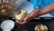 The woman puts the dough pieces in baking molds. Condenses the dough into a roasting dish. Preparation of marble cake.