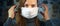 A woman puts on a gauze mask