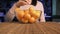 A woman puts in a glass plate on a bamboo mat, ripe juicy orange tangerines.