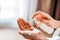 A woman puts on the hands of cosmetics from a bottle or liquid natural soap. Body care concept