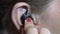 A woman puts the headset on her ear to listen