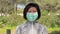 A woman puts on a mask to her face to protect against coronavirus, in the park after training. Spring allergy