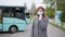 Woman puts on a medical mask to protect against virus and infection, observing modern safety standards in public places